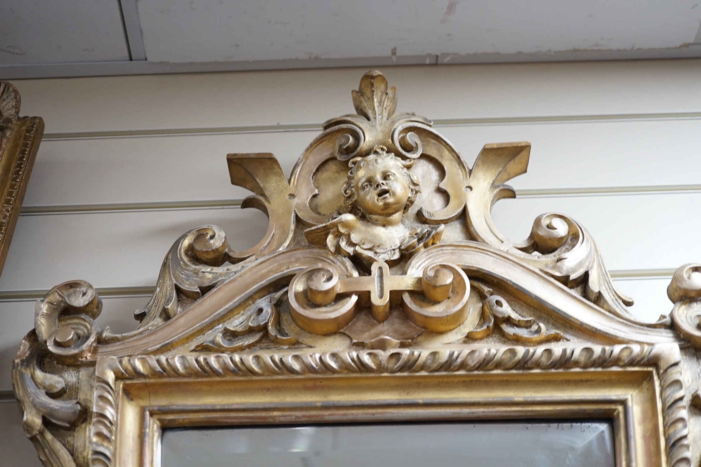 A late 19th century Continental giltwood cartouche shaped wall mirror, width 54cm, height 100cm *Please note the sale commences at 9am.